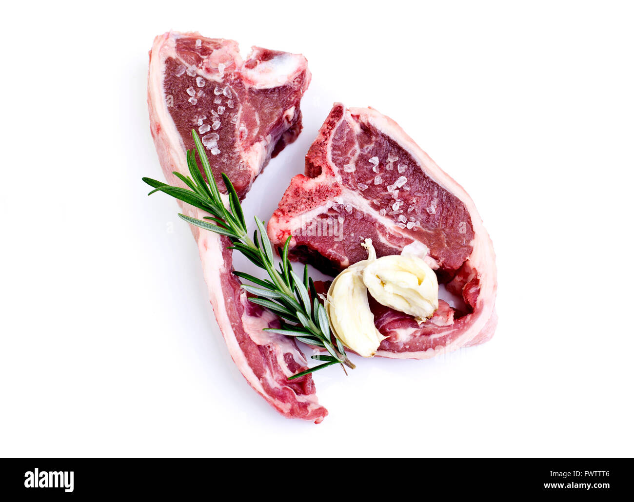 Raw lamb loin chops with rosemary, garlic and salt isolated over white background Stock Photo
