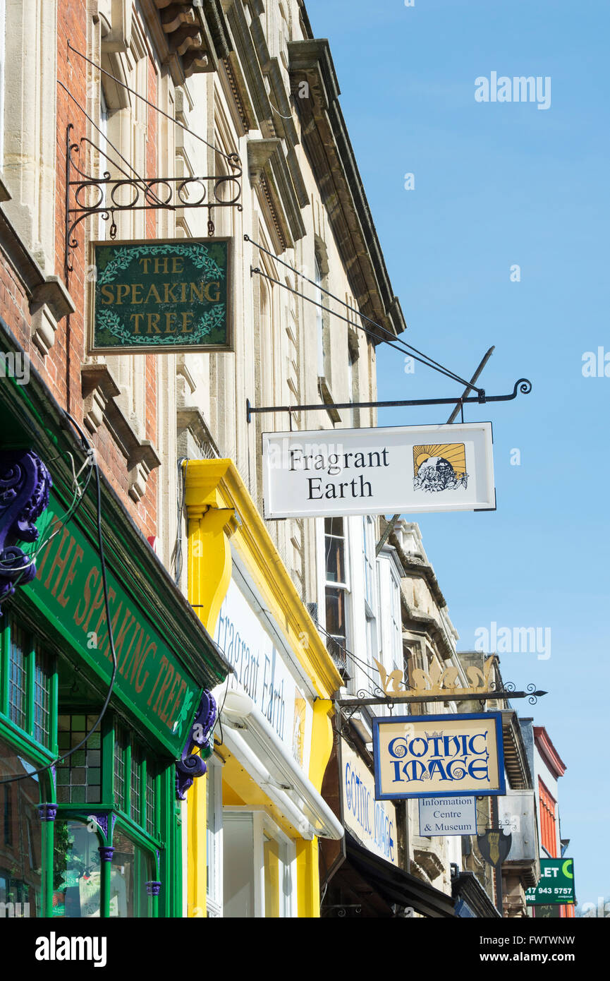 Shop front signs in the high street. Glastonbury, Somerset, England Stock Photo