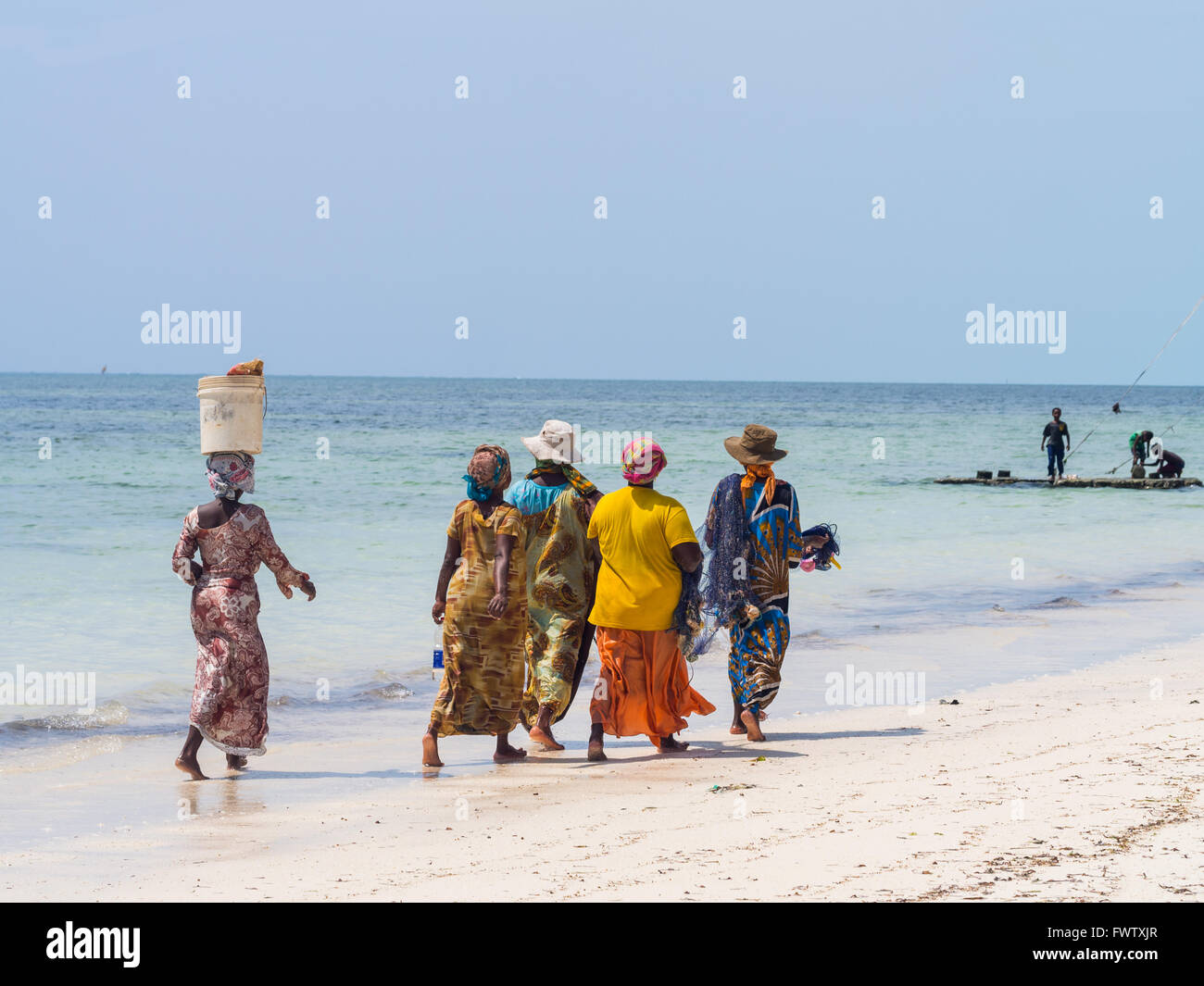 Local women going fishing on a beach in Zanzibar, Tanzania. Stock Photo