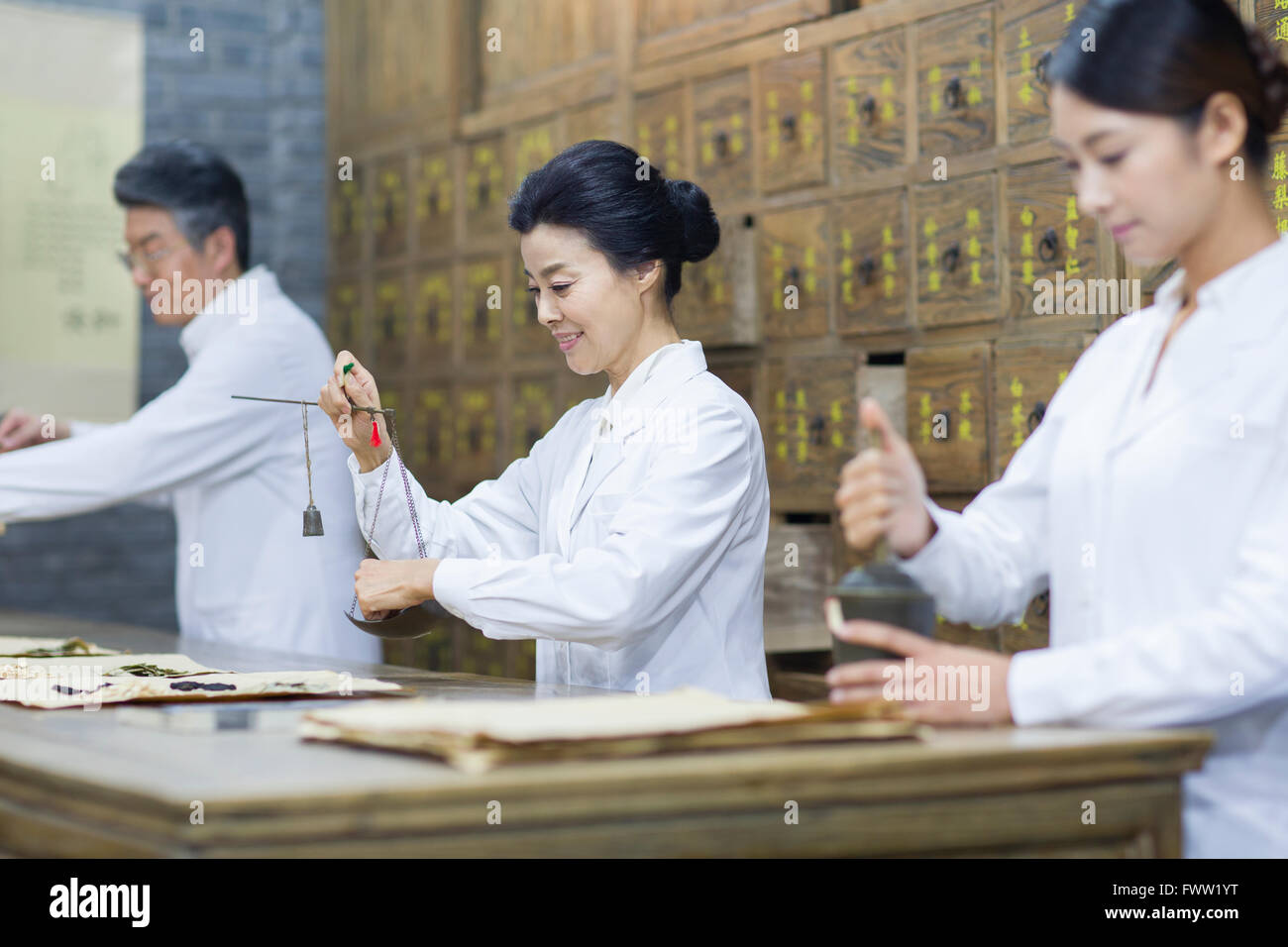 Chinese doctors in traditional Chinese medicine pharmacy Stock Photo