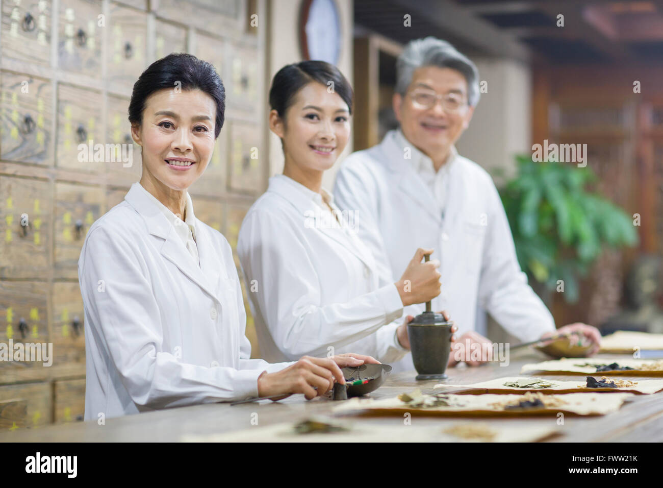 Chinese doctors in traditional Chinese medicine pharmacy Stock Photo