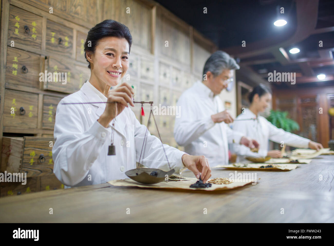 Chinese doctors in traditional Chinese medicine pharmacy Stock Photo