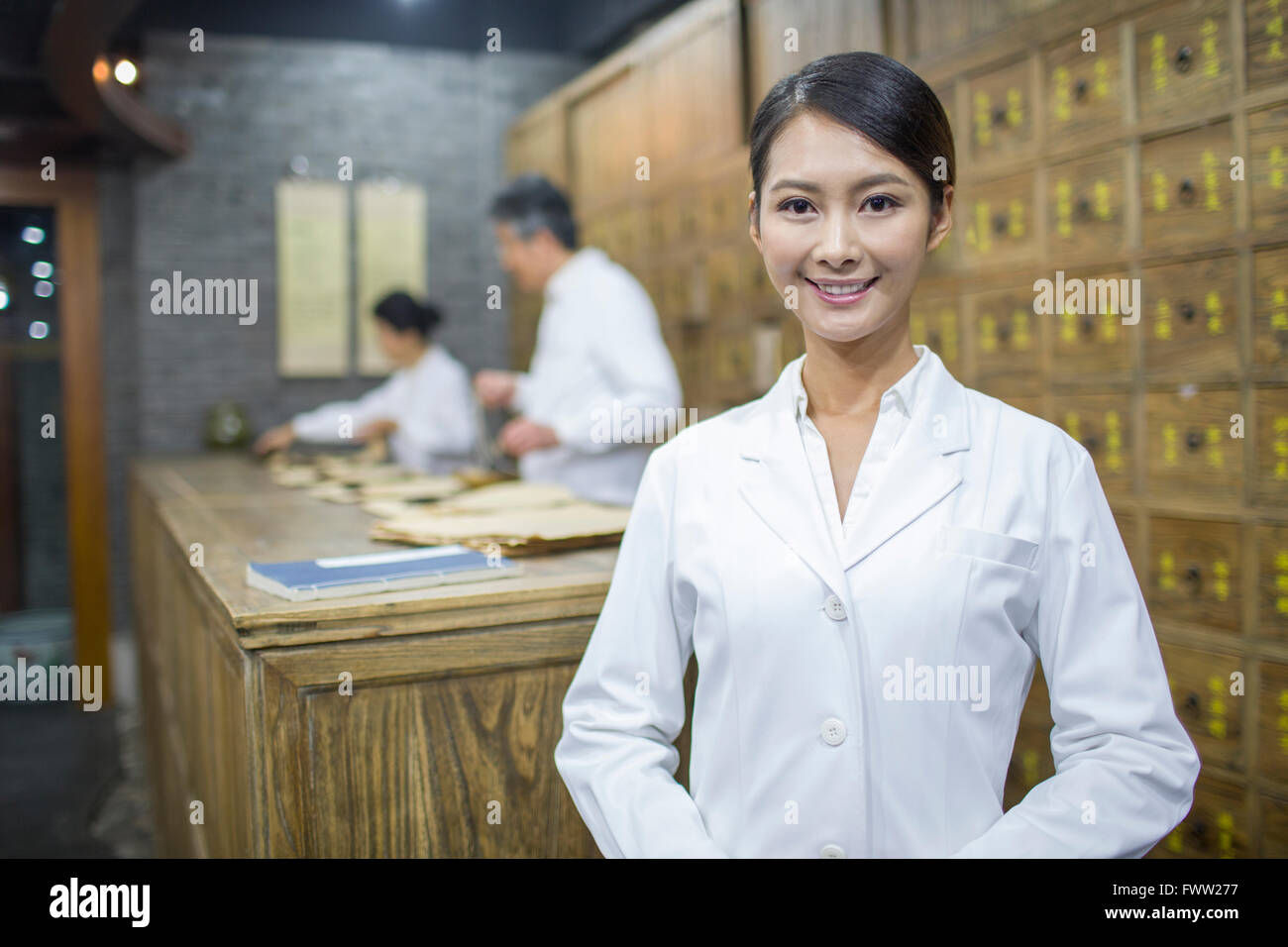 Chinese doctors in traditional Chinese medicine pharmacy Stock Photo
