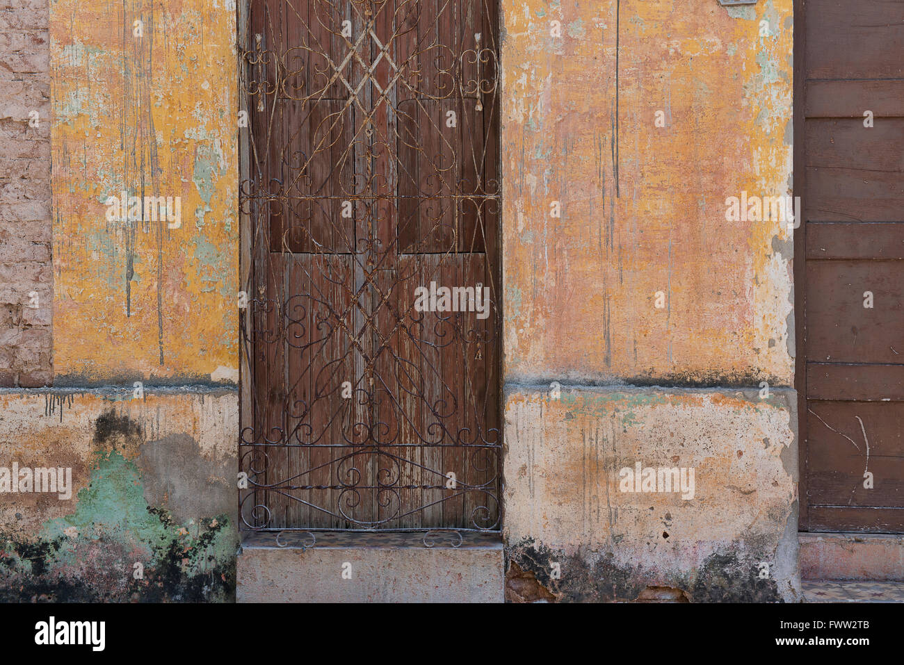 A wall of different colors and textures in the old Cuban town of Trinidad. Stock Photo