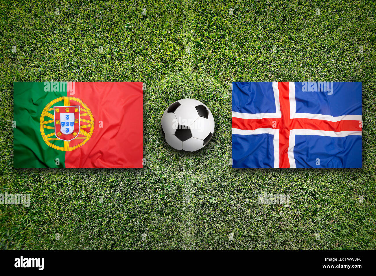 Portugal vs. Iceland flags on green soccer field Stock Photo