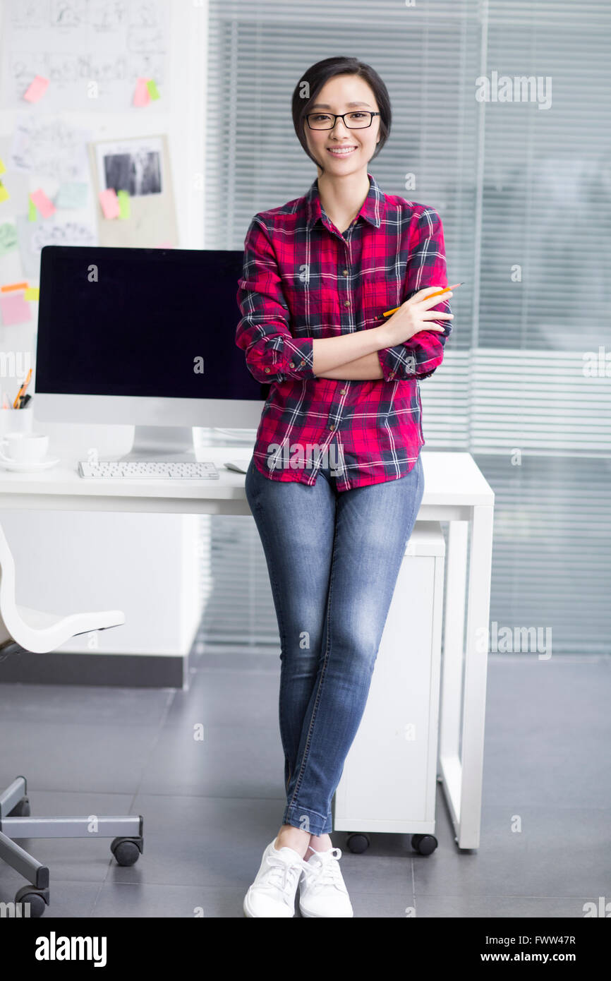 Woman crossed legs standing office hi-res stock photography and images ...