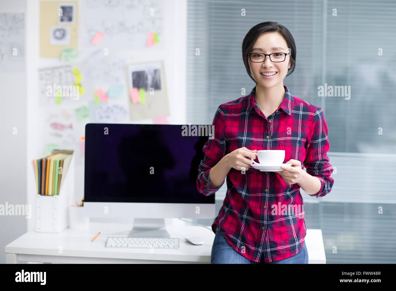 Young woman taking a coffee break Stock Photo - Alamy