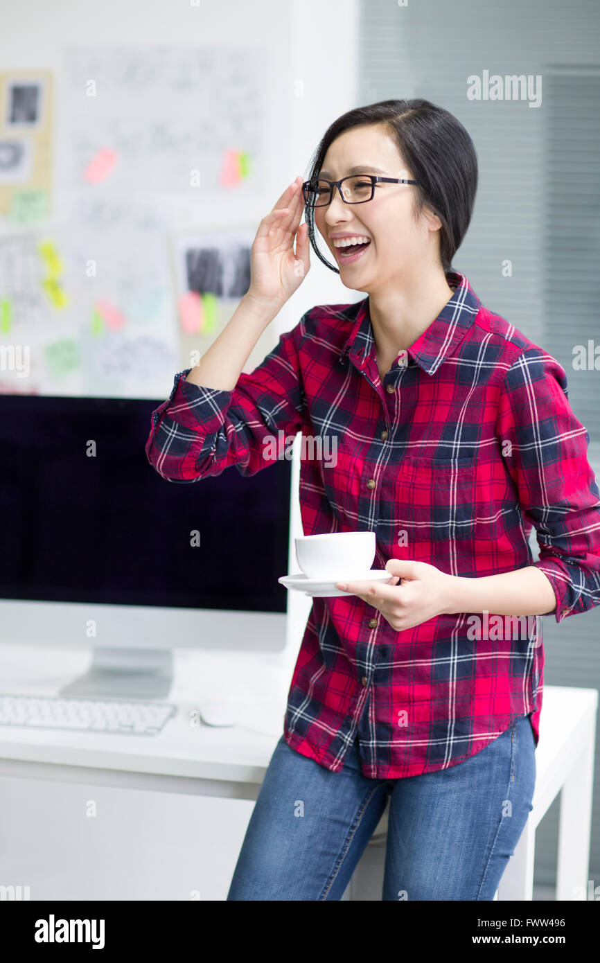 Young woman taking a coffee break Stock Photo - Alamy