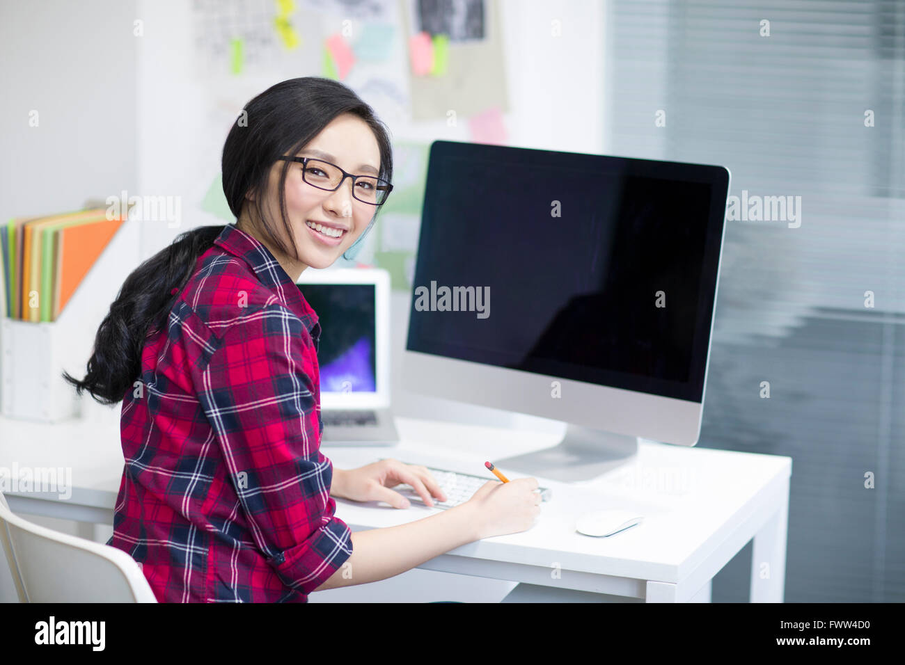Young woman working in office Stock Photo