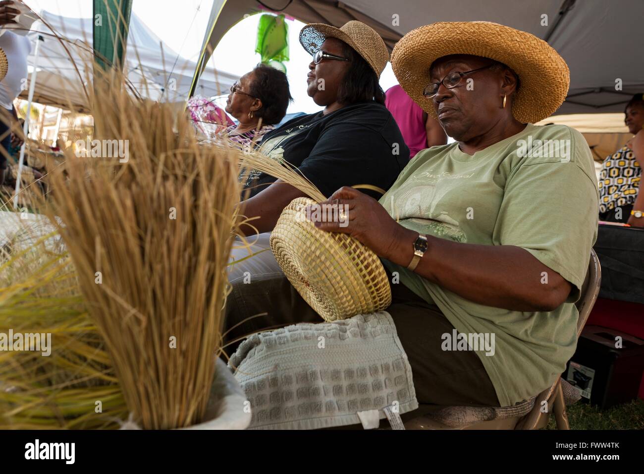 Gullah women weave sweetgrass straw baskets in the tradition of their ancestors enslaved from