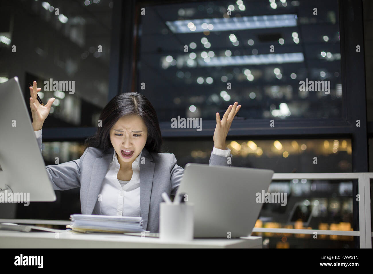 Businesswoman working late in office Stock Photo - Alamy