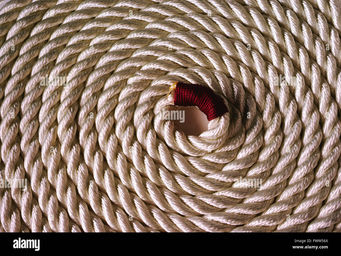 Heavy coiled white marina rope Stock Photo