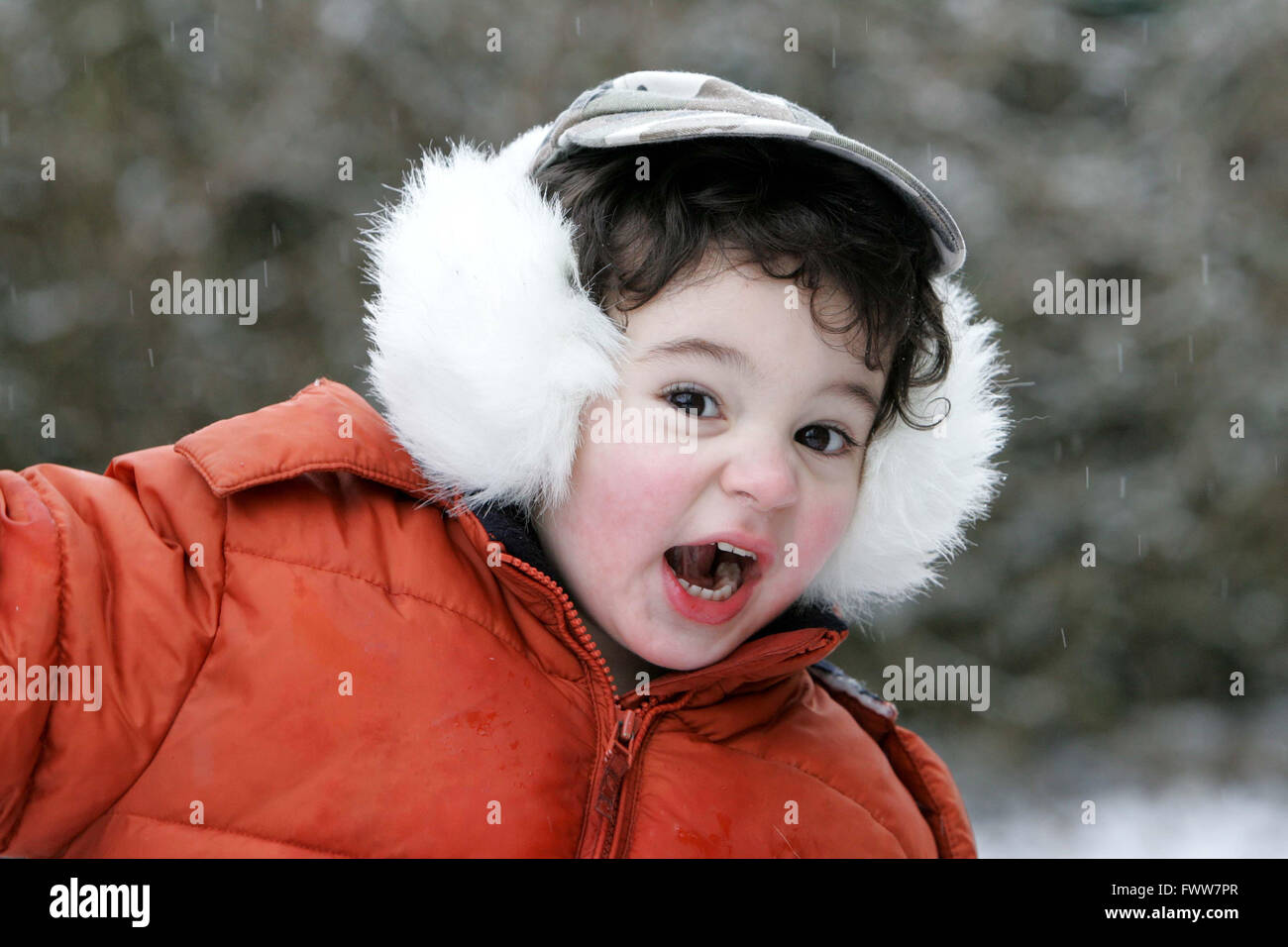 toddler boy playing in snow Stock Photo