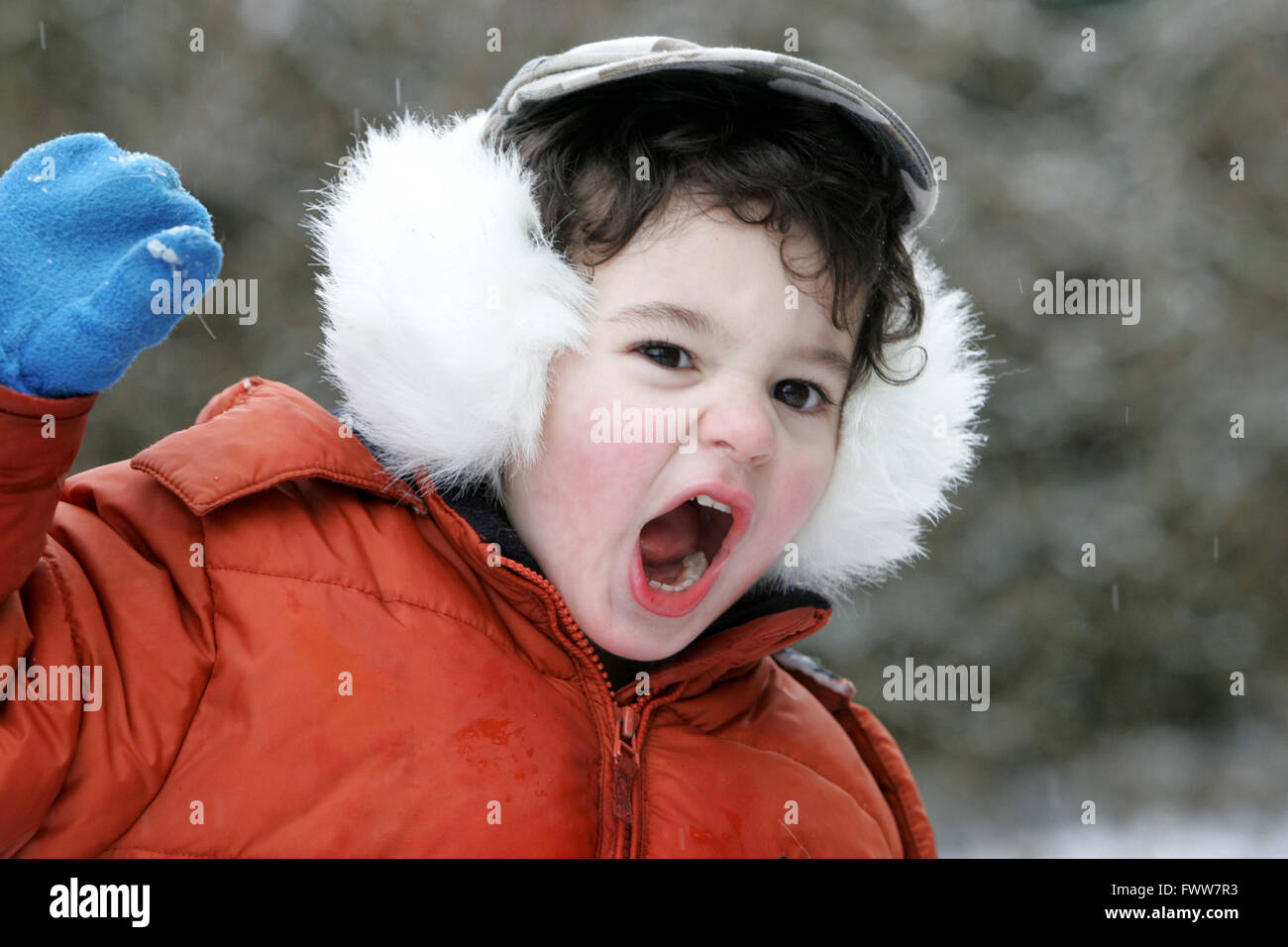 toddler boy playing in snow Stock Photo