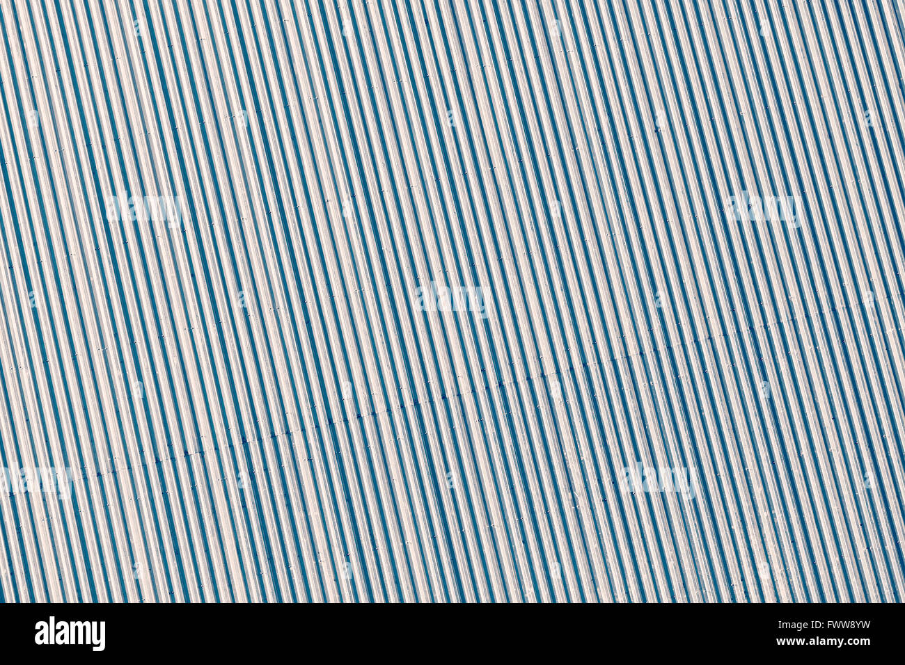 Blue toned corrugated metal roof, picture taken from above, industrial background or texture. Stock Photo