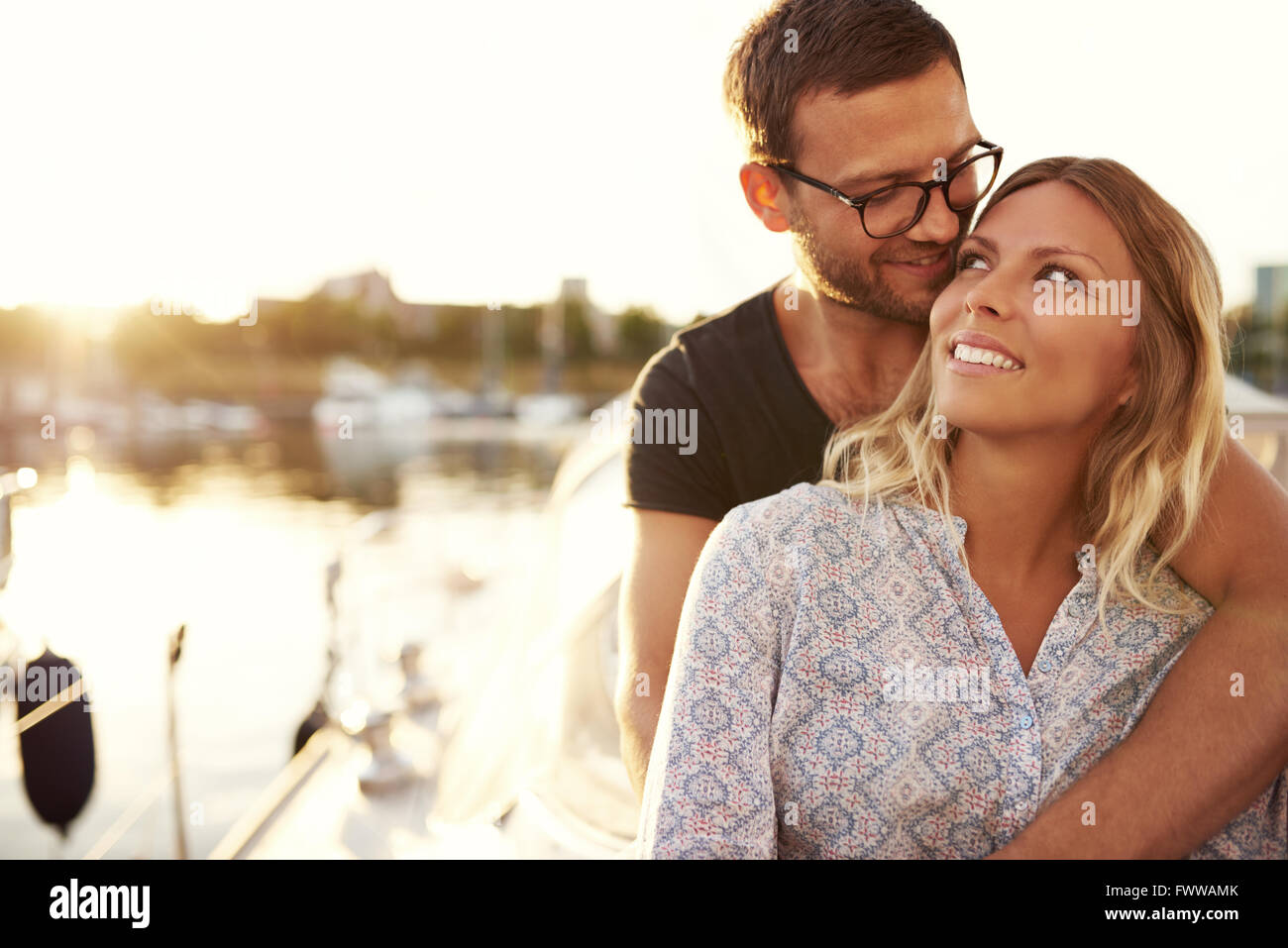 Couple Sitting on Their Boat Enjoying Life While In Love Stock Photo