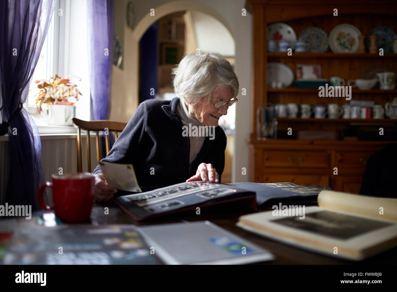 Women looking through photo album hi-res stock photography and images ...