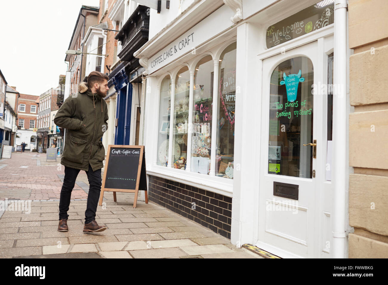 Man Walking To Coffee Shop Stock Photo