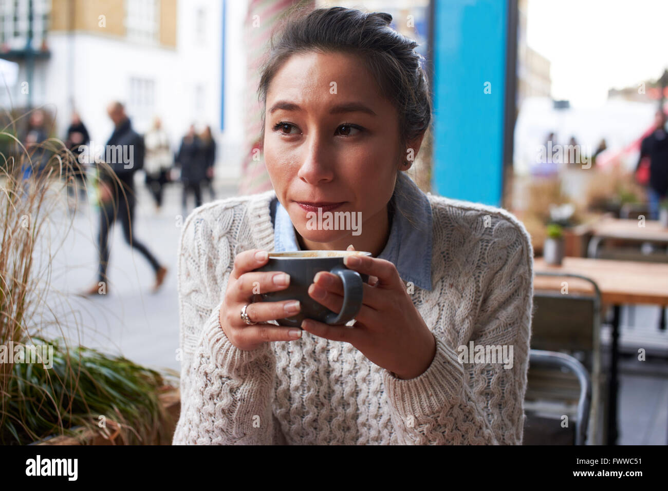 Young Woman Relaxing In Coffee Shop Stock Photo - Alamy
