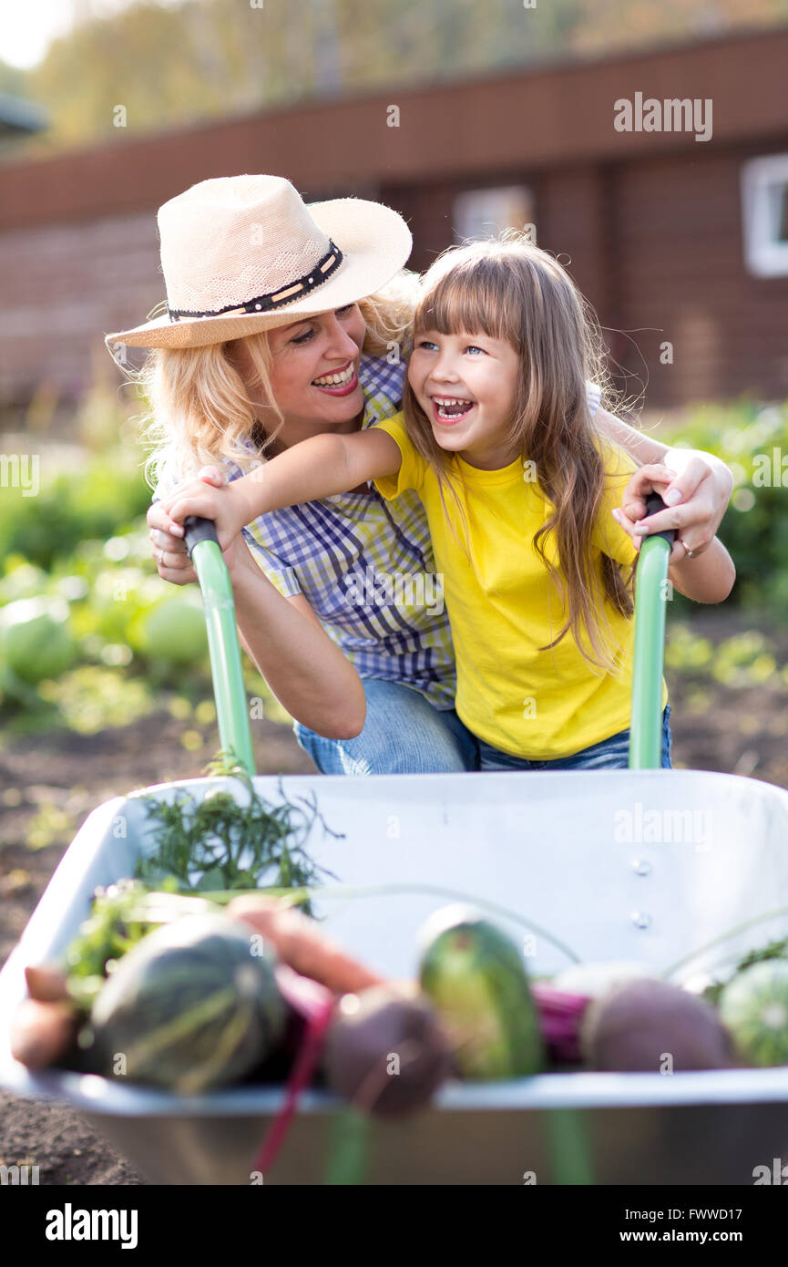 little child girl with wheelbarrow and vegetables Stock Photo - Alamy