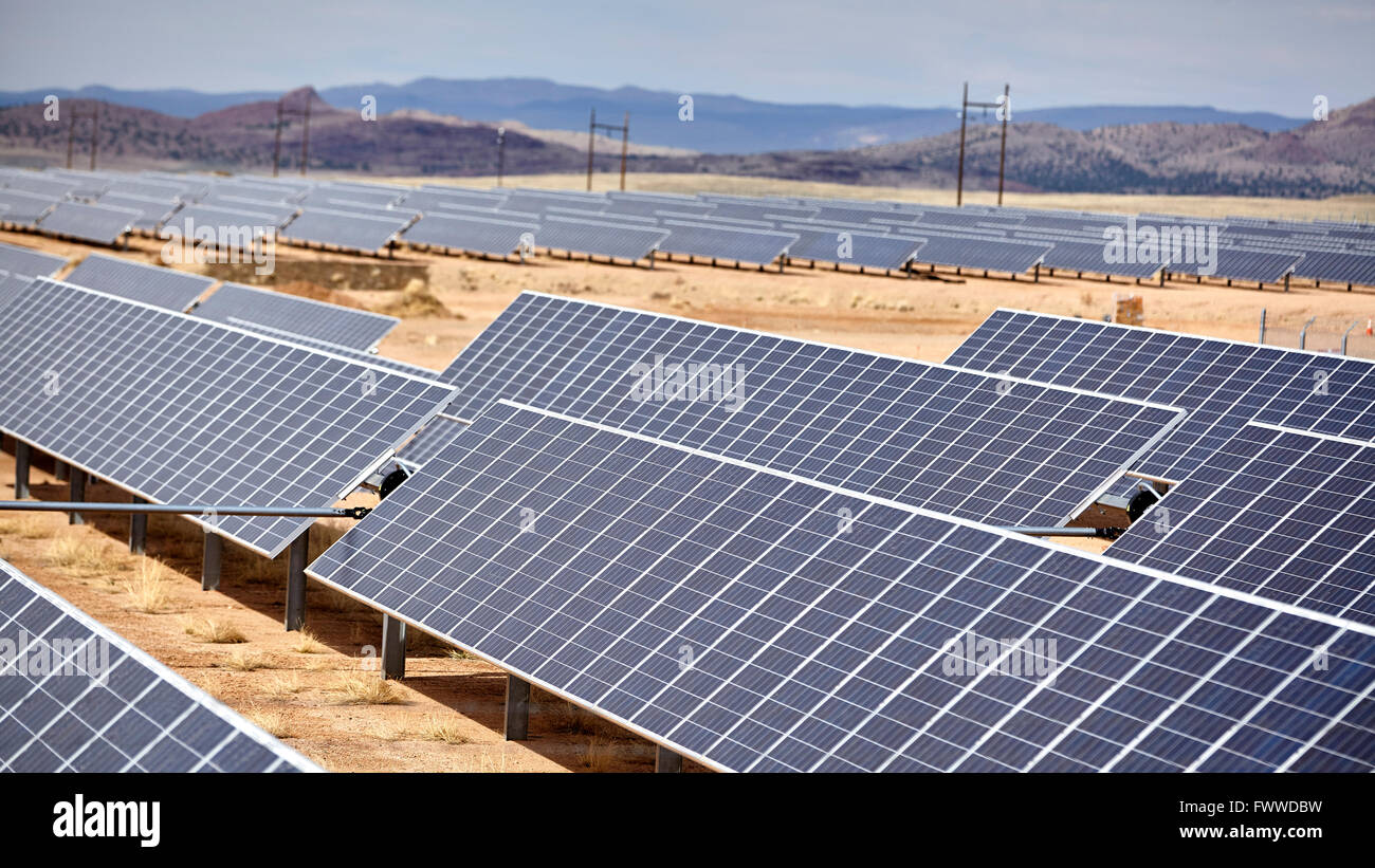 vast array of solar electric panel power utility industry grid on open countryside landscape Stock Photo
