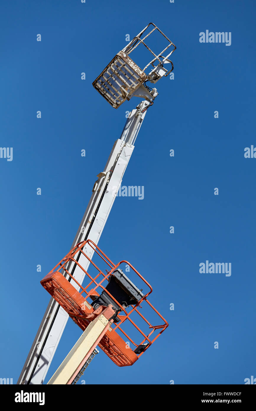 construction equipment aerial man lift boom crane in the sky Stock Photo