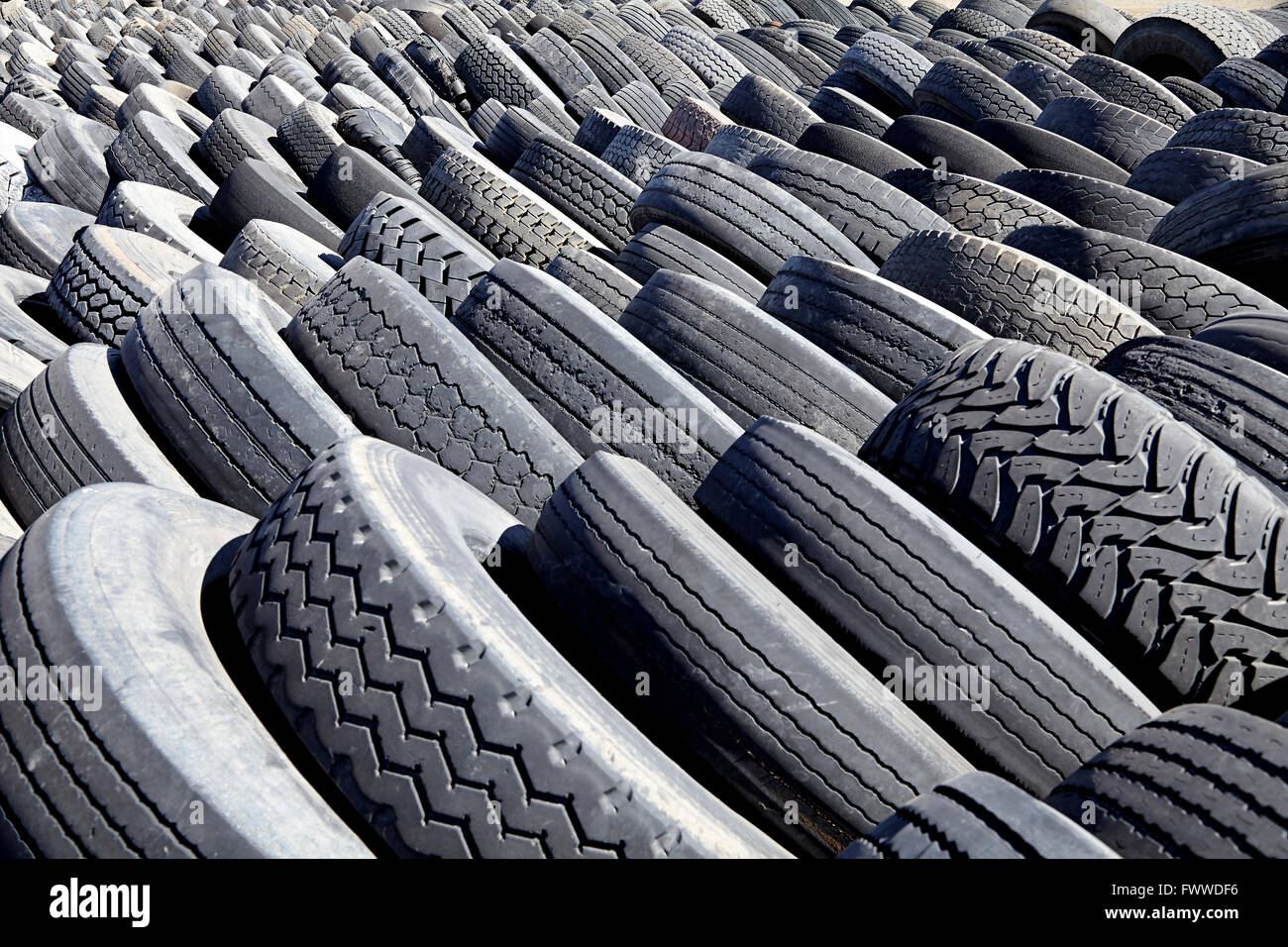 automotive and commercial tires used worn damaged for recycling waste management industry disposal Stock Photo