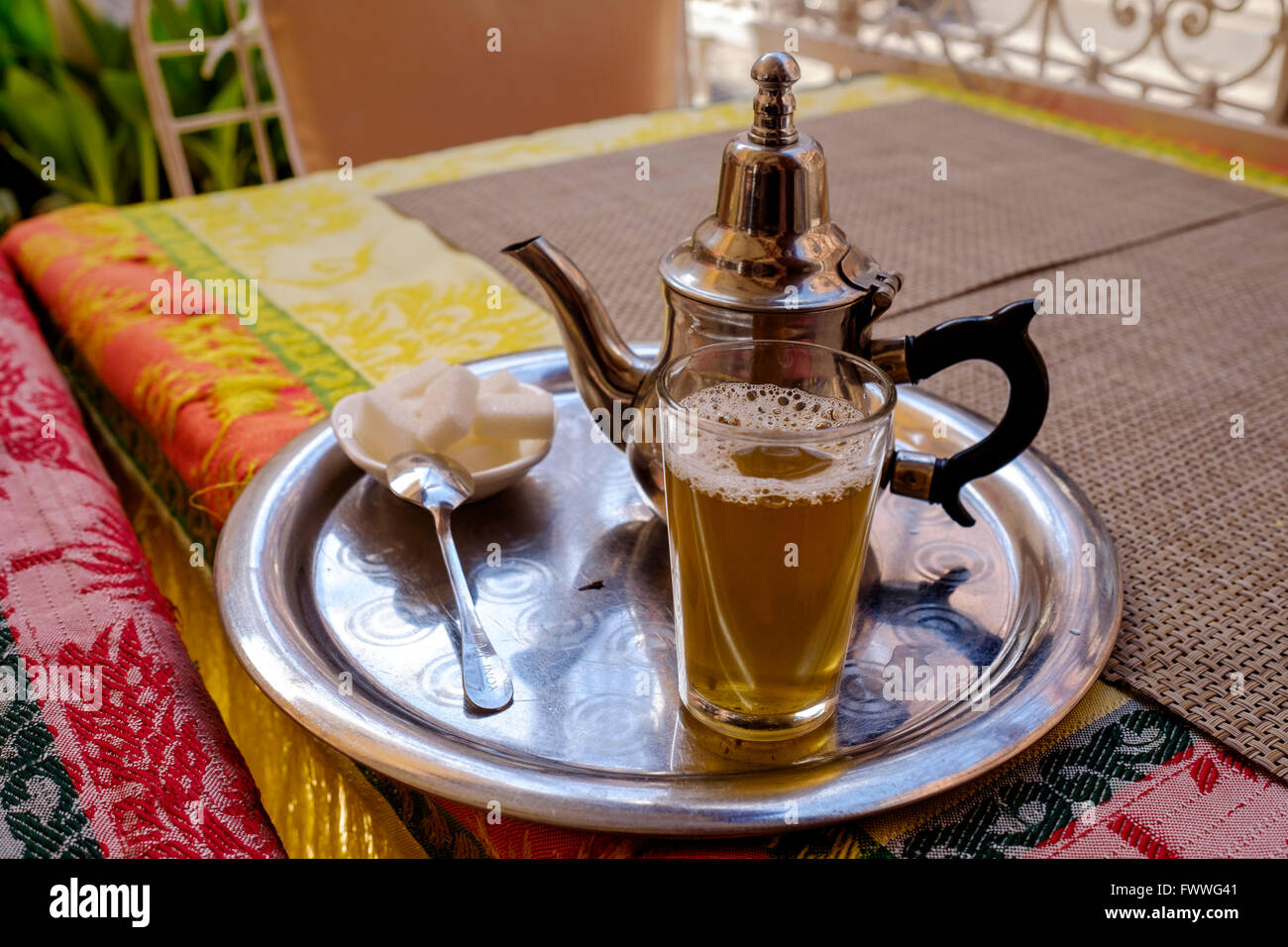 A glass of traditional mint tea served in a glass in a cafe in the ...