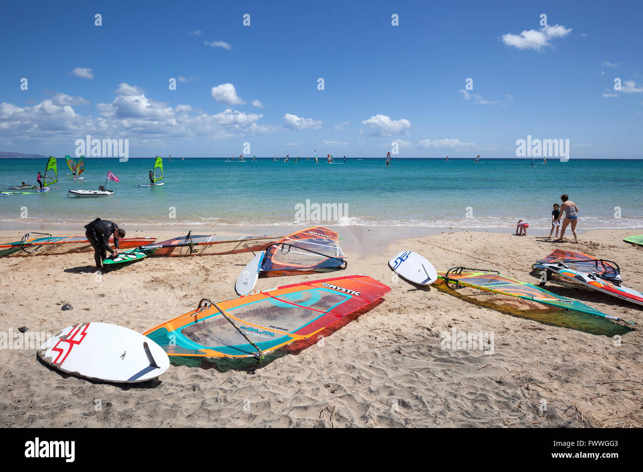 Windsurfing boards and sails lying on the beach, Playa Risco del Paso, Playa de Sotavento, Jandia, Fuerteventura, Canary Islands Stock Photo
