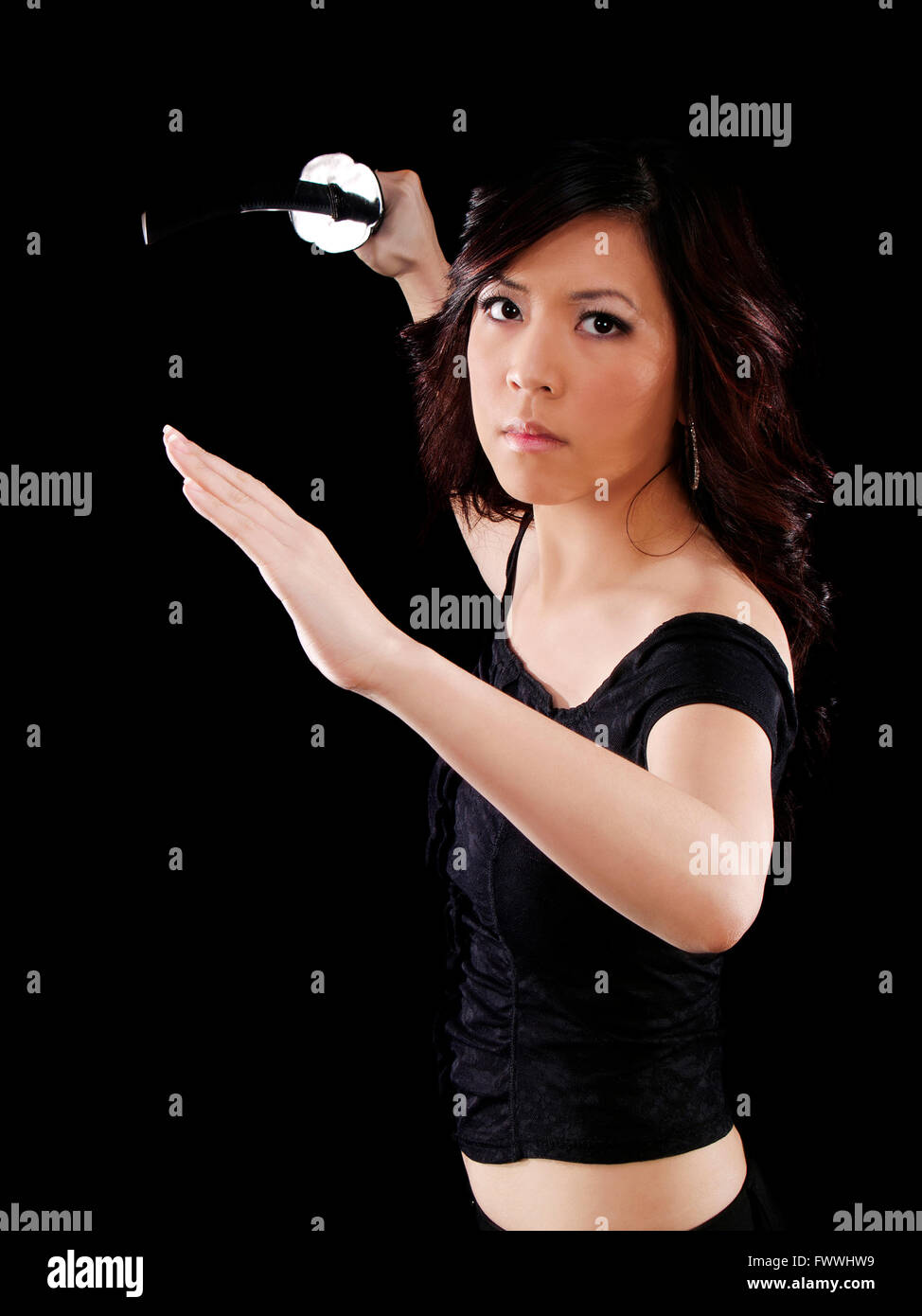 Young Oriental Woman Holding Japanese Sword Threatening Stock Photo