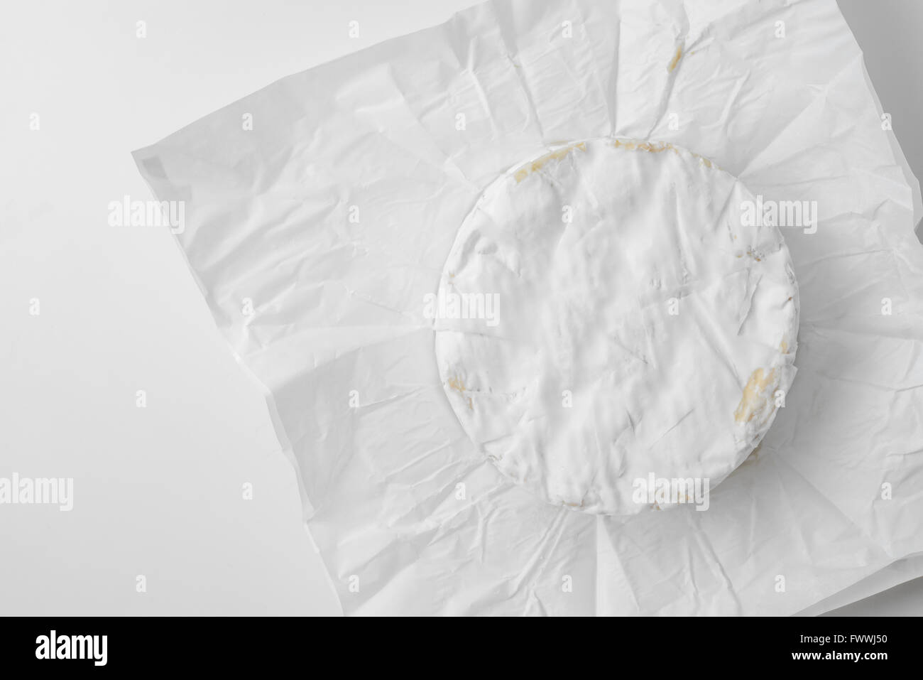 camembert cheese on wrapping paper Stock Photo
