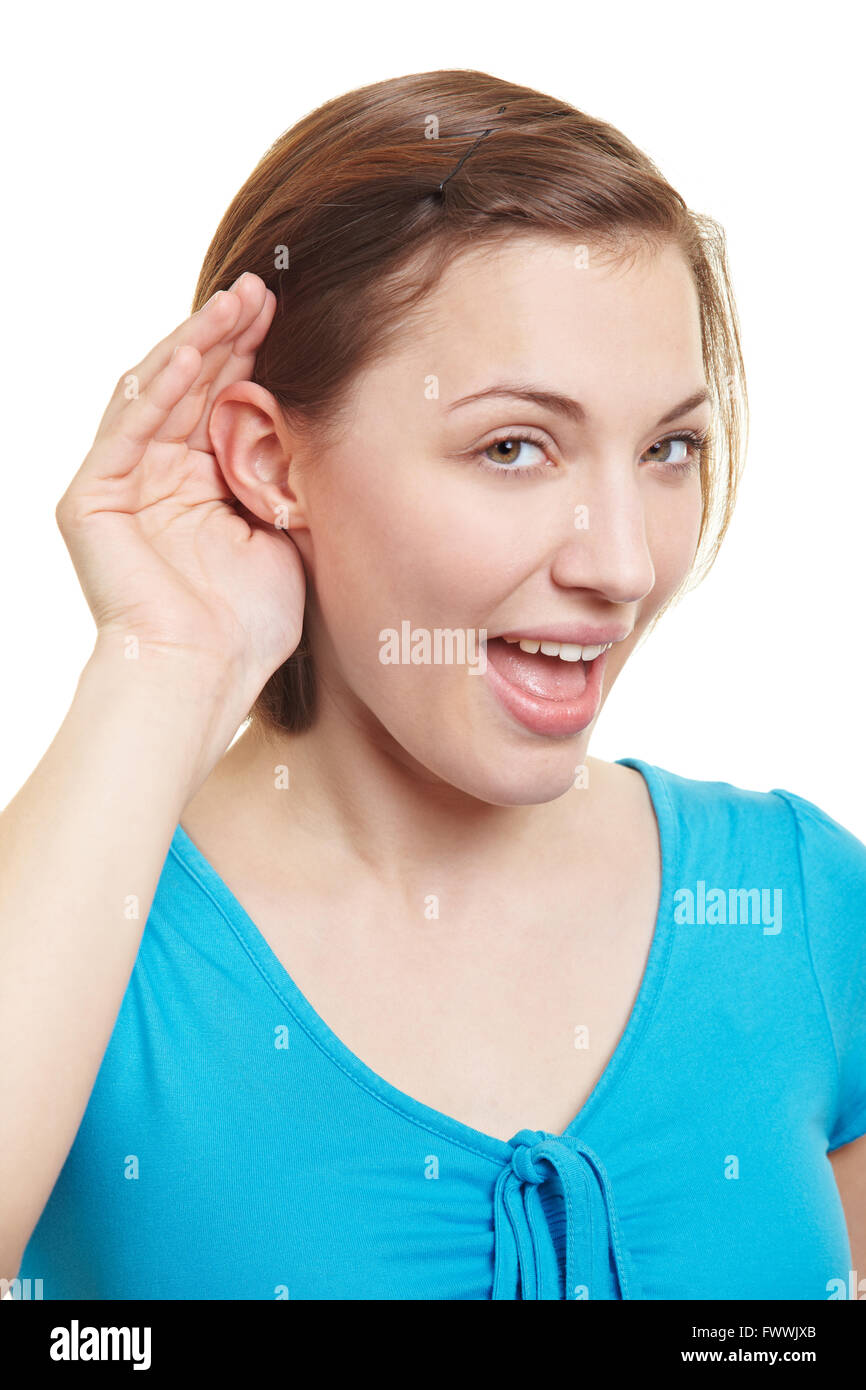 Young woman holding her hand behind her ears Stock Photo