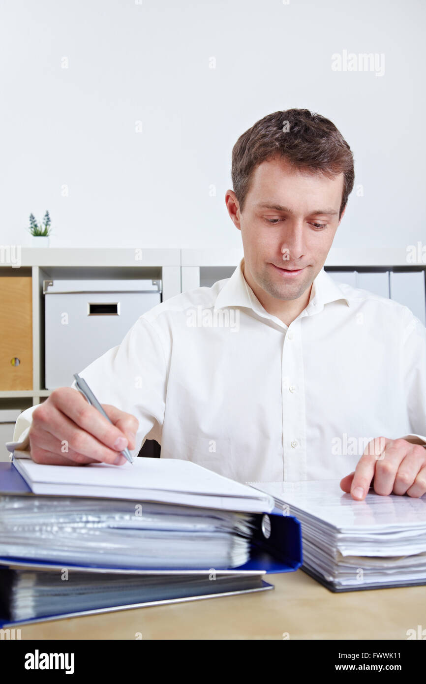 Manager working on files at his desk in his office Stock Photo Alamy