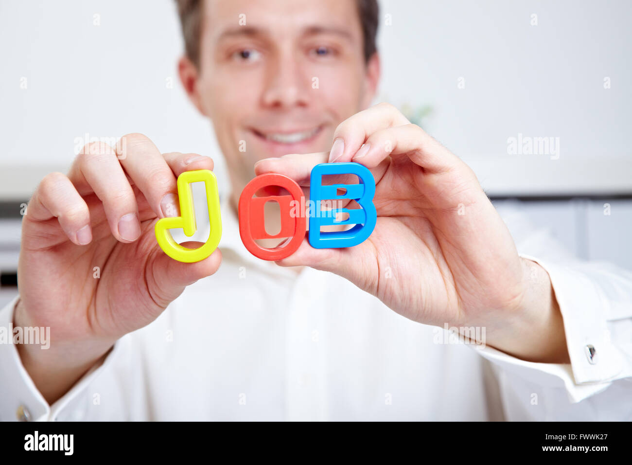 Business man looking for a job and holding these letters in his hands Stock Photo