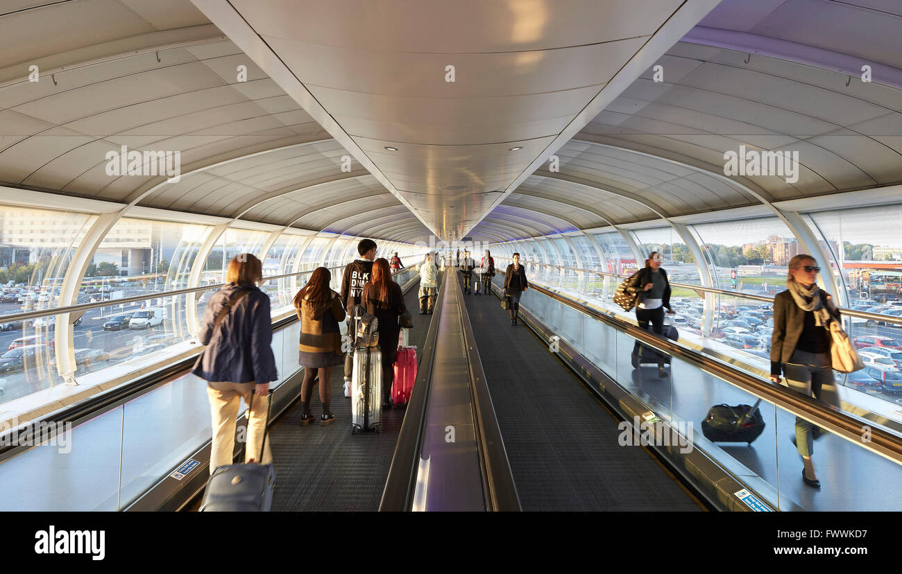 Arriving and departing travelers in Skylink Walkway. Manchester Airport, Manchester, United Kingdom. Architect: n/a, 2015. Stock Photo