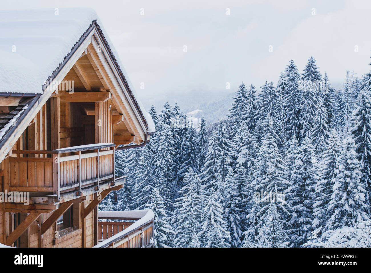winter holidays, ski vacations background, wooden house under snow in the Alps Stock Photo