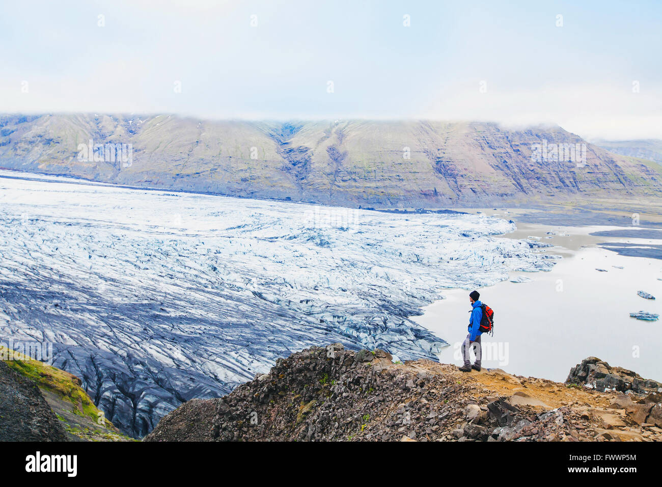 traveler enjoying panoramic view of glacier in Iceland Stock Photo