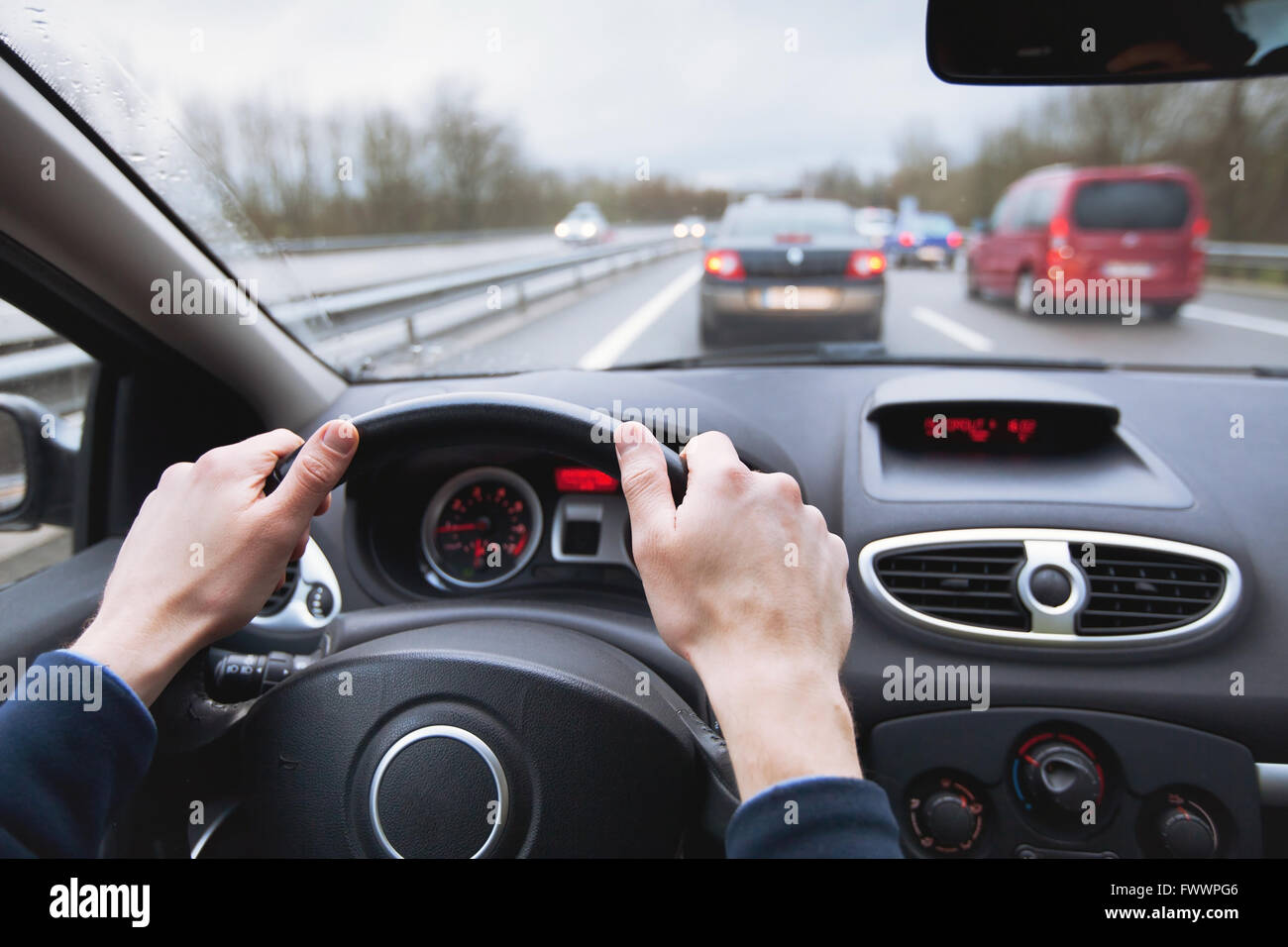 driving car on highway, close up of hands on steering wheel Stock Photo