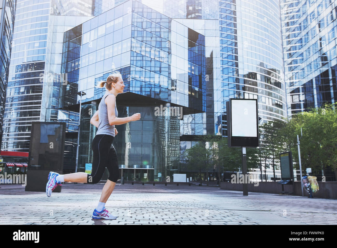 young woman running on urban background Stock Photo