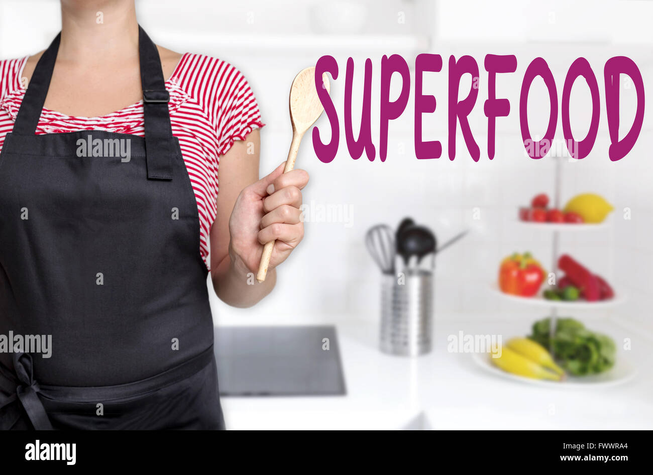 superfood cook holding wooden spoon concept background. Stock Photo