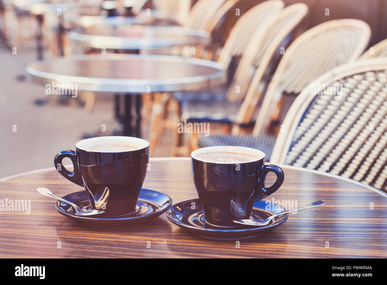 two cups of hot chocolate or coffee cappuccino on the table in cafe, close up, vintage style Stock Photo