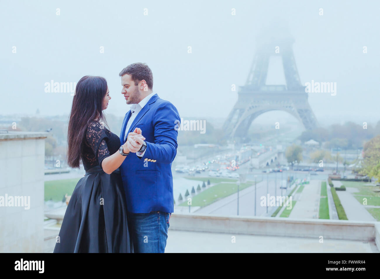 romantic moment near Eiffel tower, portrait of couple in love Stock Photo