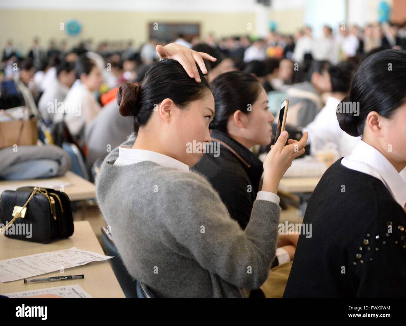 (160408) --HARBIN, April 8, 2016 (Xinhua) -- Applicants attending airline stewardess audition arrange her makeups before receiving interview in Harbin, northeast China's Heilongjiang Province,April 8, 2016. (Xinhua/Wang Kai) (yxb) Stock Photo