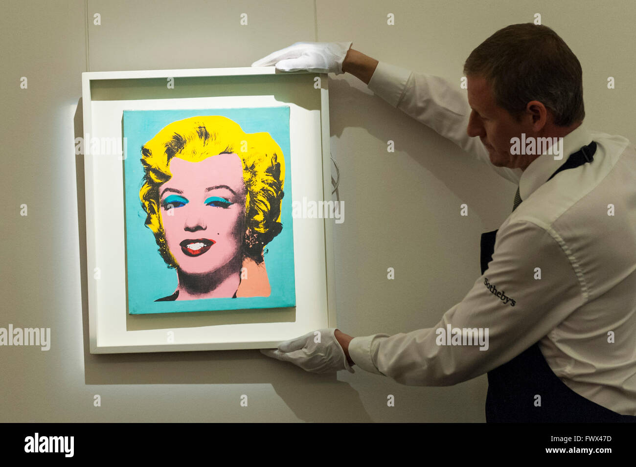 London, UK.  8 April 2016.  A Sotheby's technician hangs Elaine Sturtevant's 'Warhol's Marilyn Monroe', 1967, est. $0.3-0.4million at Sotheby's auction preview, at their New Bond Street gallery, of works to be in the upcoming New York Impressionist, modern and contemporary art sale.  Credit:  Stephen Chung / Alamy Live News Stock Photo