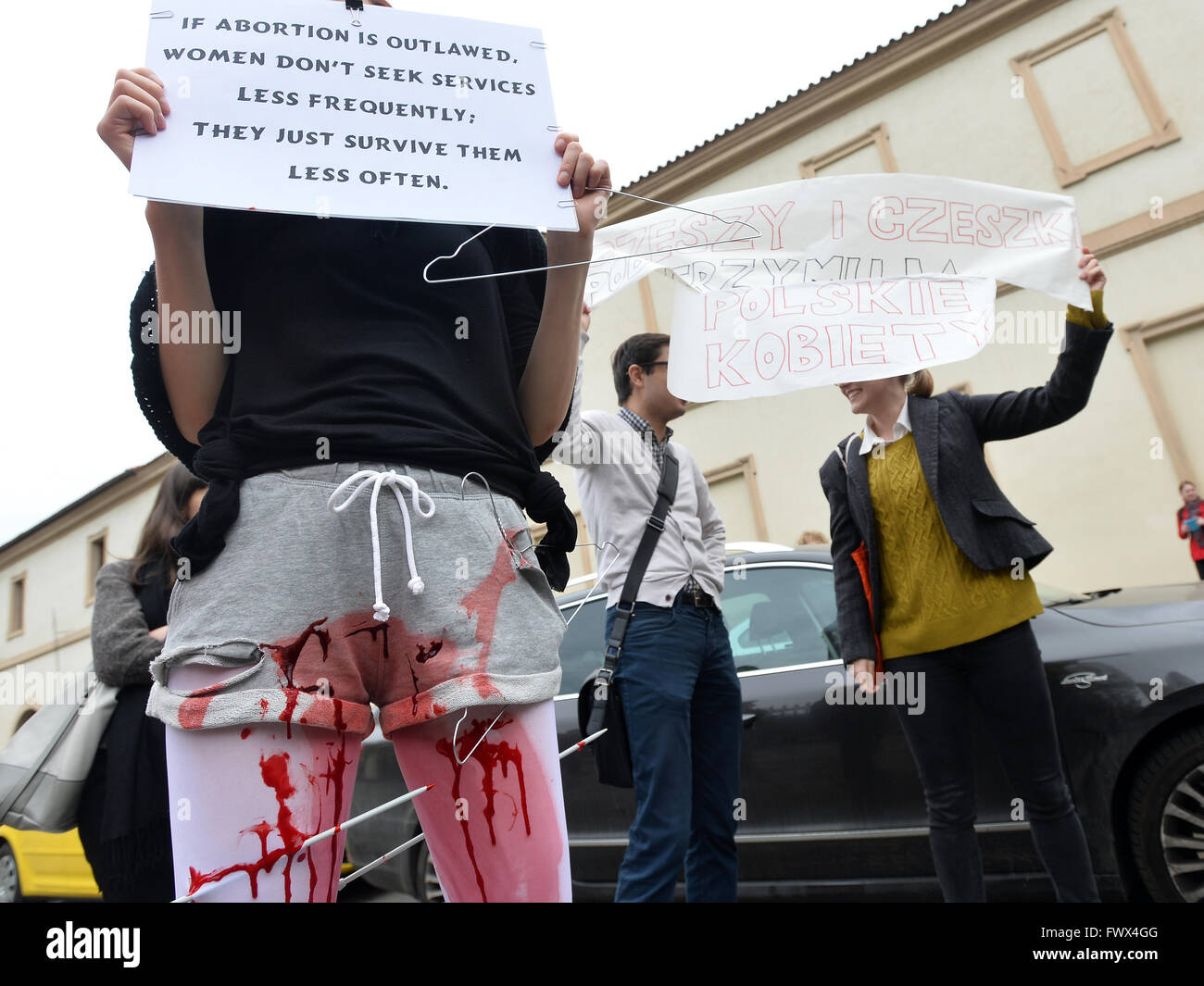 Prague, Czech Republic. 8th Apr, 2016. People holding posters and hangers, symbolizing an illegal abortion, during a happening against a possible tightening of the Poland's abortion law, already one of the most restrictive in Europe, organized by The Czech Women's Lobby (CWL) in front of The Embassy of the Republic of Poland in Prague, Czech Republic, on Friday, April 8, 2016. Credit:  Katerina Sulova/CTK Photo/Alamy Live News Stock Photo