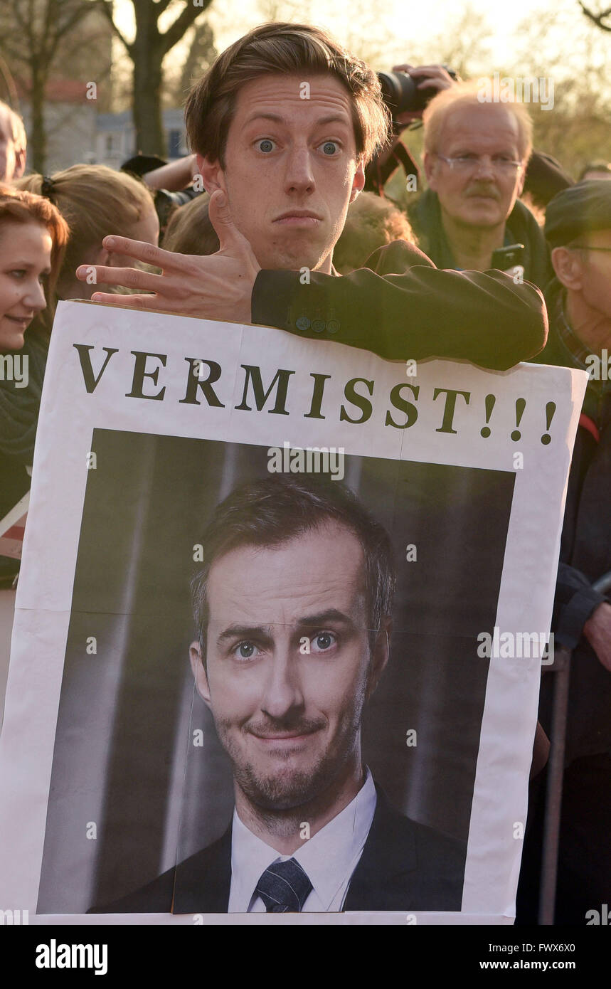 Actor Max Mauff holds up a poster written with 'missing' referring to the absence of the satirist Jan Boehmermann ahead of the Grimme Award ceremony in Marl, Germany, 08 April 2016. Photo: HENNING KAISER/dpa Stock Photo