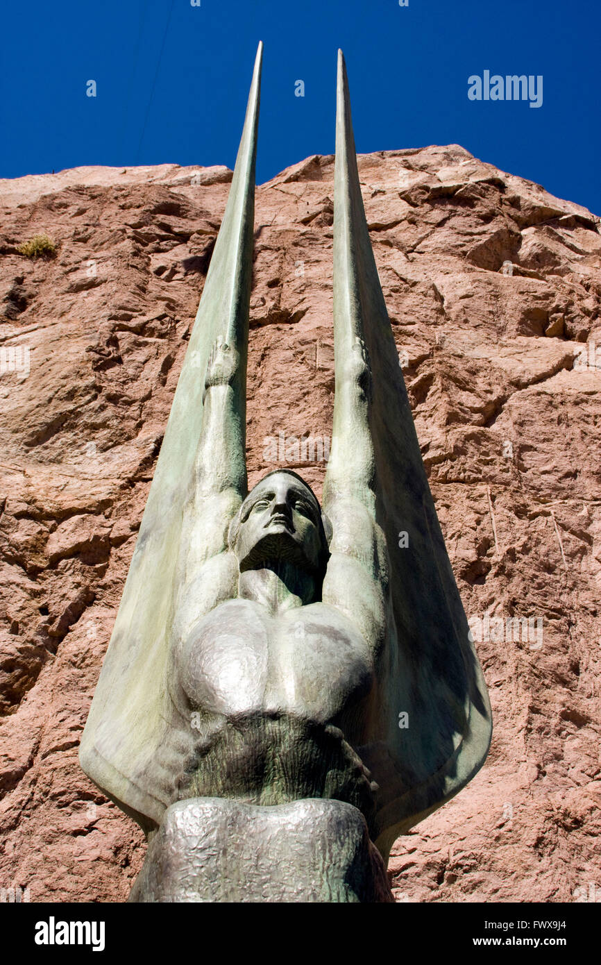 Winged Sculpture statue with rock and blue sky in the background at Hoover Dam Stock Photo