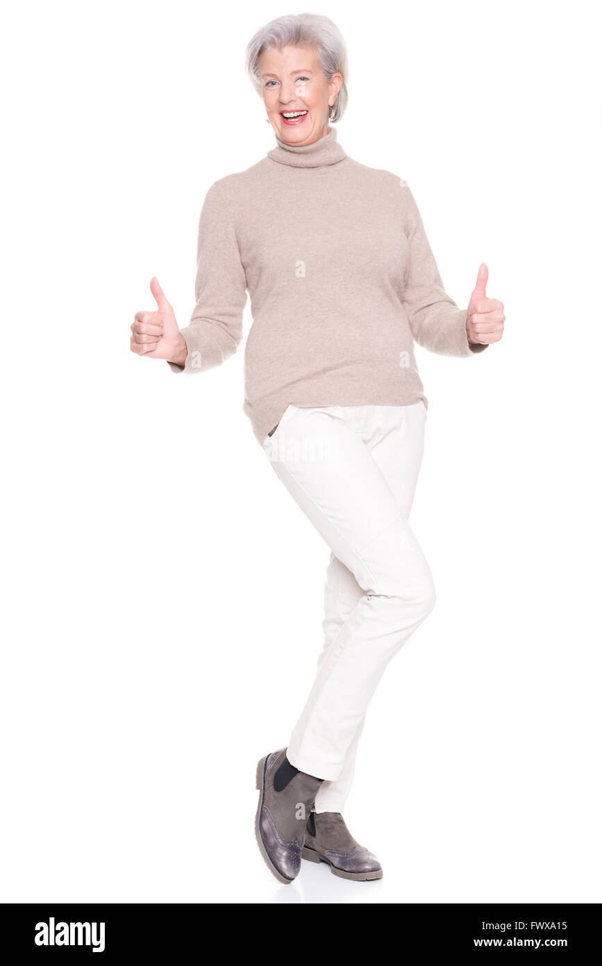 Senior woman standing in front of white background Stock Photo - Alamy