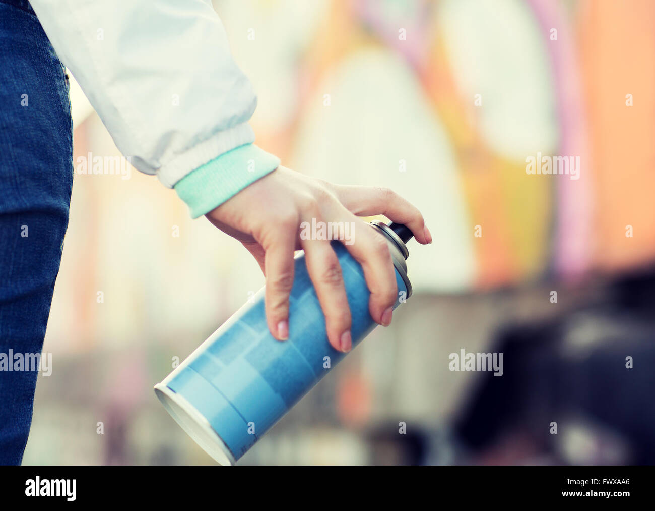 close up of hand holding spray paint and graffiti Stock Photo - Alamy