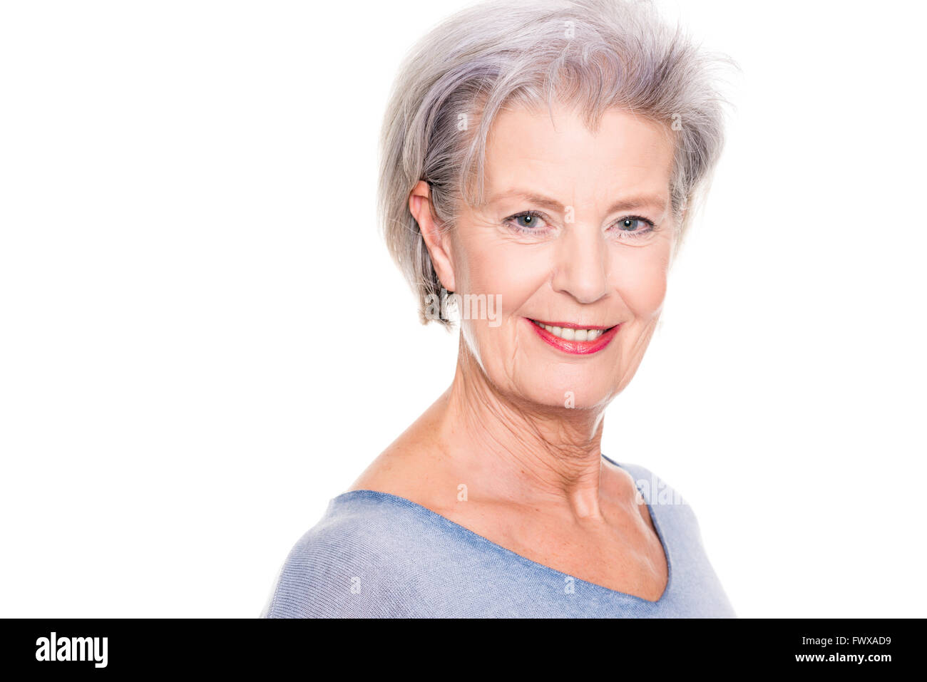 Smiling senior woman in front of white background Stock Photo - Alamy